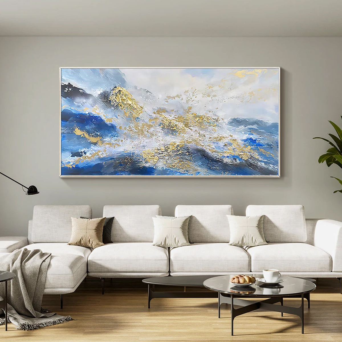 Modern abstract mountain canvas painting above living room sofa