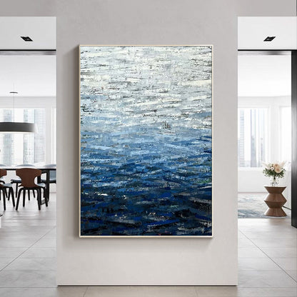 Contemporary coastal wall art above modern living room sofa